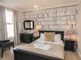 A bedroom with bed and decorative items at 11 Rutland Street Filey