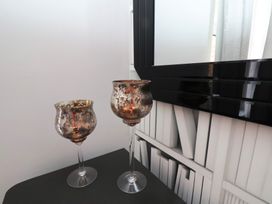 Two candlesticks on a table with a mirror in the background at 11 Rutland Street