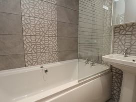 A bathroom with a bathtub and sink at 11 Rutland Street in Filey