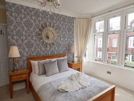 A bedroom with a bed and bedside table at 11 Rutland Street, Filey
