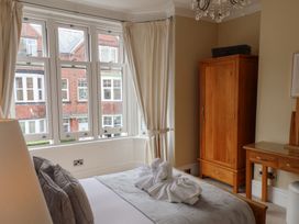 A bedroom with a bed and wardrobe at 11 Rutland Street, Filey