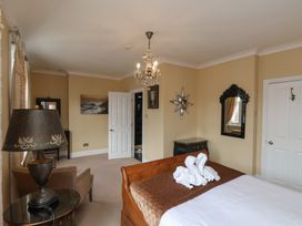 A bedroom with a bed and lamp at 11 Rutland Street, Filey