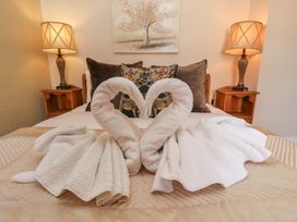 A bedroom with a towel swan display on the bed at 11 Rutland Street in Filey