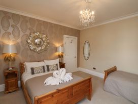 A bedroom with a double bed and a single bed at 11 Rutland Street in Filey