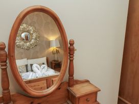 A bedroom with a mirror and a bed at 11 Rutland Street Filey