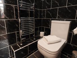 A bathroom with a toilet and towel rail at 11 Rutland Street in Filey