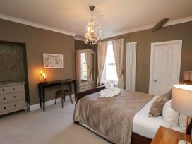 A bedroom with a bed, dresser, and chair at 11 Rutland Street in Filey