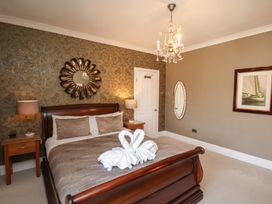A bedroom with a bed and decorative items at 11 Rutland Street in Filey