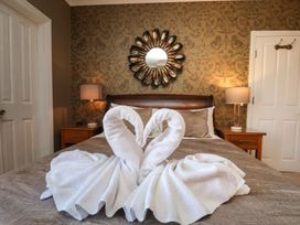 A bedroom with towel swans on the bed at 11 Rutland Street in Filey