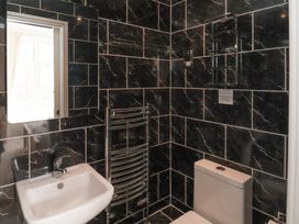 A bathroom with sink, toilet, and radiator at 11 Rutland Street Filey