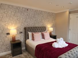 A bedroom with a bed and bedside tables at 11 Rutland Street in Filey