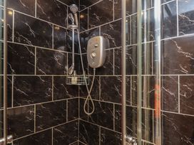 A shower with black wall tiles at 11 Rutland Street Filey