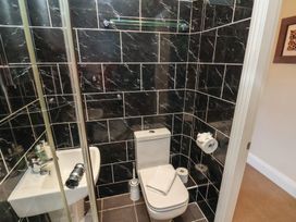 A bathroom with a toilet, sink, and shower at 11 Rutland Street Filey