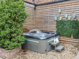 A garden with a hot tub and decorative planters at 11 Rutland Street Filey