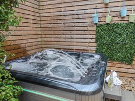 A hot tub surrounded by wood fence and plants at 11 Rutland Street Filey