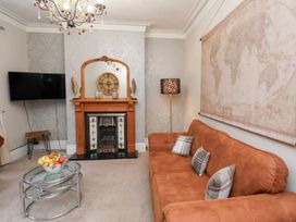 A living room with a sofa and television at All Seasons in Filey