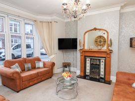 A living room with a fireplace and a television at All Seasons in Filey