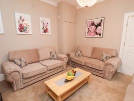 A living room with sofas and a table at All Seasons in Filey