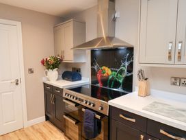 A kitchen with a stove and cabinets at All Seasons in Filey