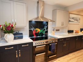 A kitchen with a range and cabinets at All Seasons in Filey