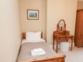 A bedroom with a bed and vanity at All Seasons in Filey