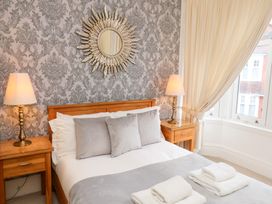 A bedroom with a bed and lamps at All Seasons in Filey