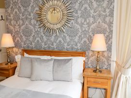 A bedroom with a bed and lamps at All Seasons in Filey