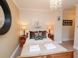 A bedroom with a bed and lamps at All Seasons in Filey