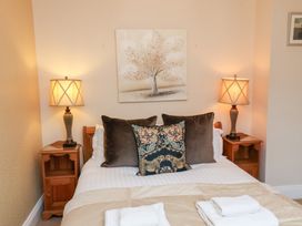 A bedroom with a bed and lamps at All Seasons in Filey