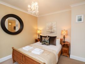 A bedroom with a bed and lamps at All Seasons in Filey