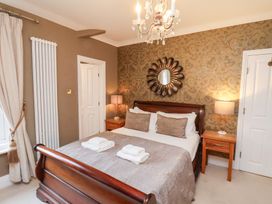 A bedroom with a bed and nightstands at All Seasons in Filey