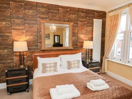 A bedroom with a bed and bedside tables at All Seasons in Filey
