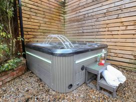 A hot tub with towels and drinks in an outdoor area at All Seasons in Filey