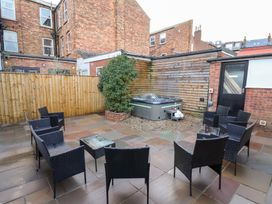 An outdoor area with seating and a hot tub at All Seasons in Filey