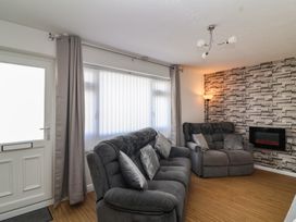 A living room with a sofa and armchair at Flat 8 in Burnham-on-Sea