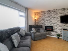 A living room with sofas and a fireplace at Flat 8 in Burnham-on-Sea