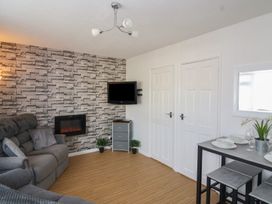 A living room with a sofa and dining table at Flat 8 in Burnham-on-Sea