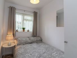 A bedroom with a bed and a window at Flat 8 in Burnham-on-Sea