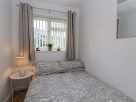 A bedroom with a bed and curtains at Flat 8 Burnham-on-Sea