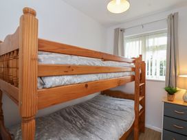 A bedroom with a bunk bed and nightstand at Flat 8 in Burnham-on-Sea