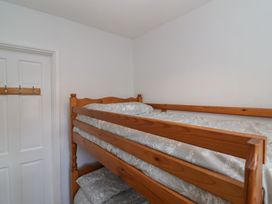 A bunk bed with sheets in a bedroom at Flat 8 in Burnham-on-Sea