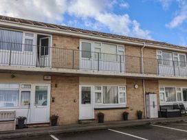 An exterior view of a building with balconies and parking spaces at Flat 8 Burnham-on-Sea