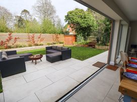 A garden patio with outdoor seating and a fire pit visible from the dining area at Natterjacks in Syderstone