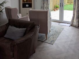A living room with a sofa and armchairs at La Bastille in Maenclochog