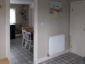 A dining room with a table and chairs at La Bastille in Maenclochog