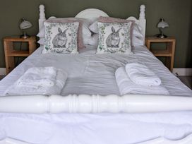 A bedroom with a bed and pillows at La Bastille in Maenclochog