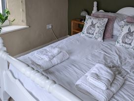A bedroom with a bed and pillows at La Bastille in Maenclochog
