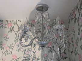 A chandelier with crystal elements in a room at La Bastille in Maenclochog