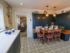 A dining room with a table and chairs at La Bastille in Maenclochog