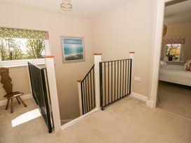 A landing with a staircase and window at La Bastille in Maenclochog